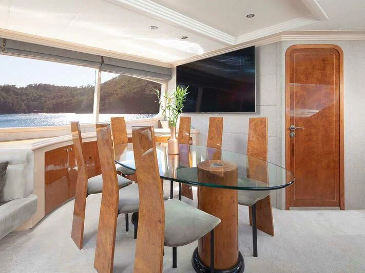 a table and chairs on a patio aboard BLANCO Yacht for Sale