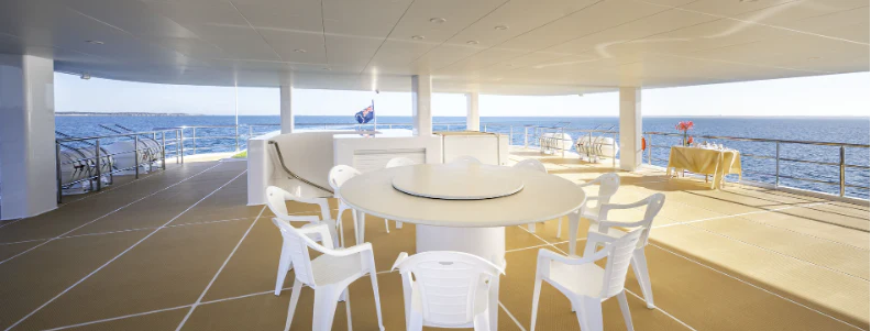 a table and chairs on a deck aboard CHARLEY 2 Yacht for Sale