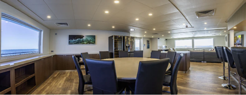 a room with a table chairs and a large window aboard CHARLEY 2 Yacht for Sale