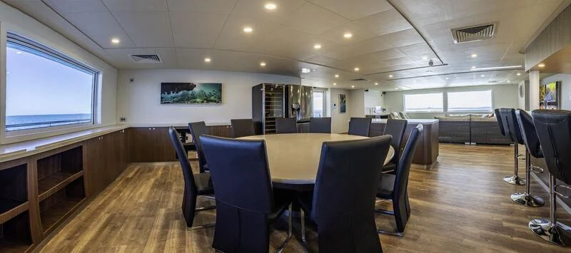 a room with a table and chairs aboard CHARLEY 2 Yacht for Sale