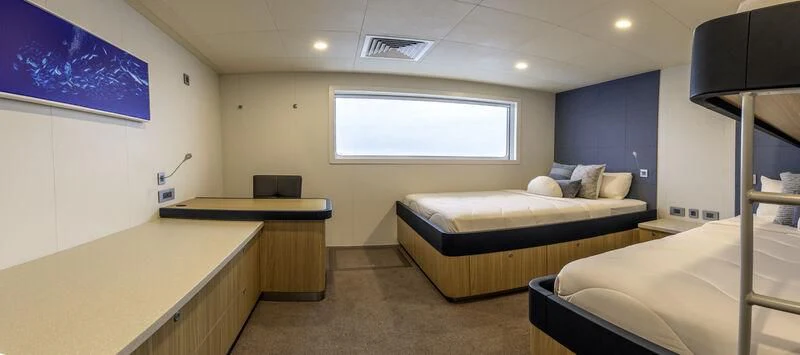 a room with a bed and a desk aboard CHARLEY 2 Yacht for Sale