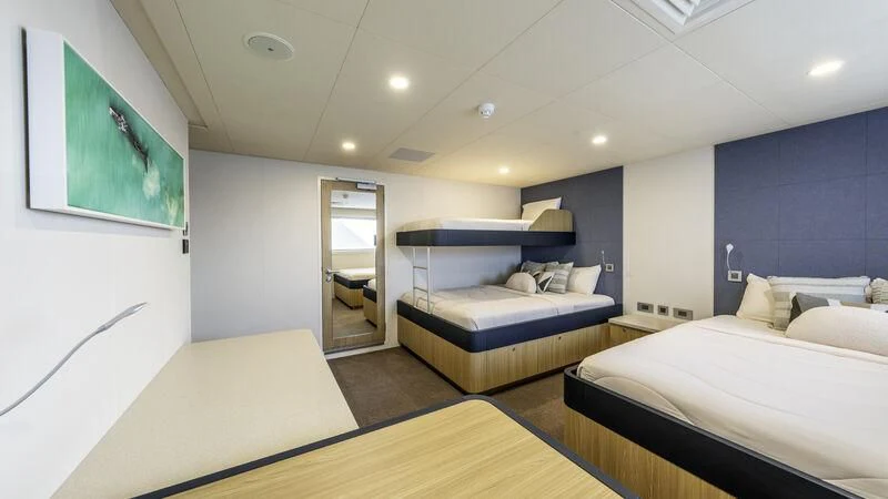 a room with a bed and a mirror aboard CHARLEY 2 Yacht for Sale
