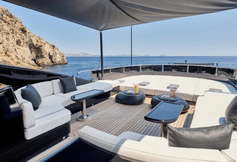a patio with a table and chairs aboard ABILITY Yacht for Sale
