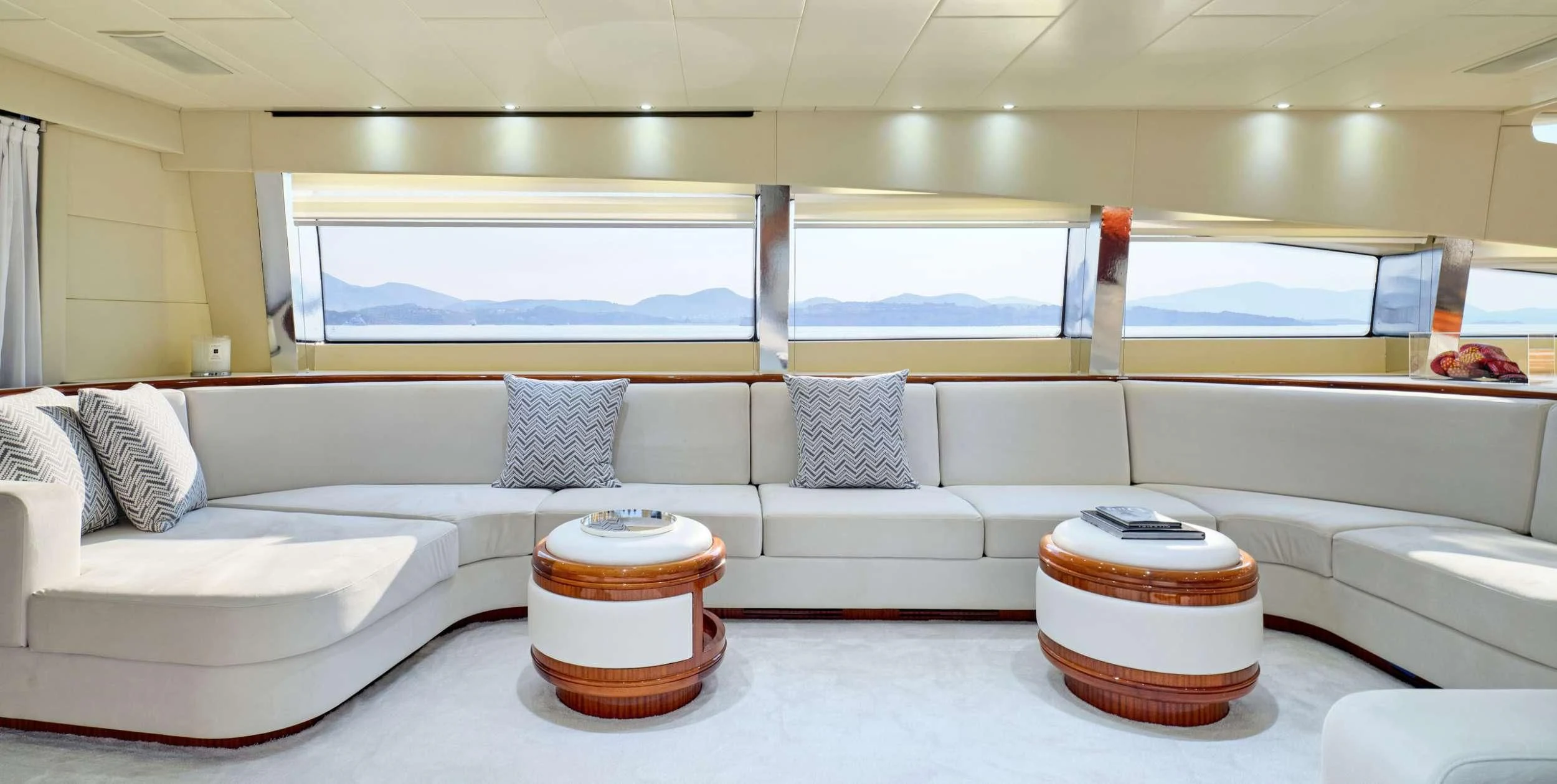 a room with a couch and a table with a window aboard ABILITY Yacht for Sale