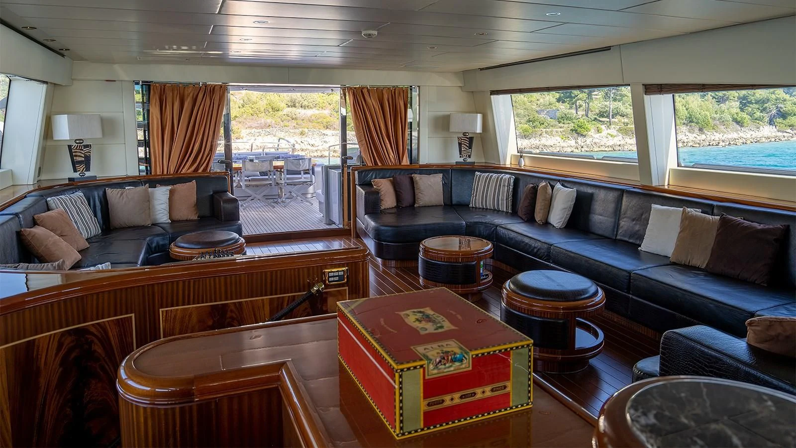 a living room with a large sofa and a coffee table aboard ABILITY Yacht for Sale