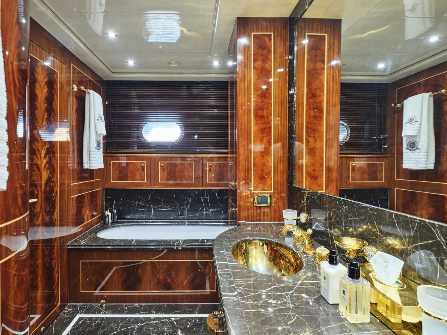 a bathroom with a sink and a large mirror aboard ABILITY Yacht for Sale