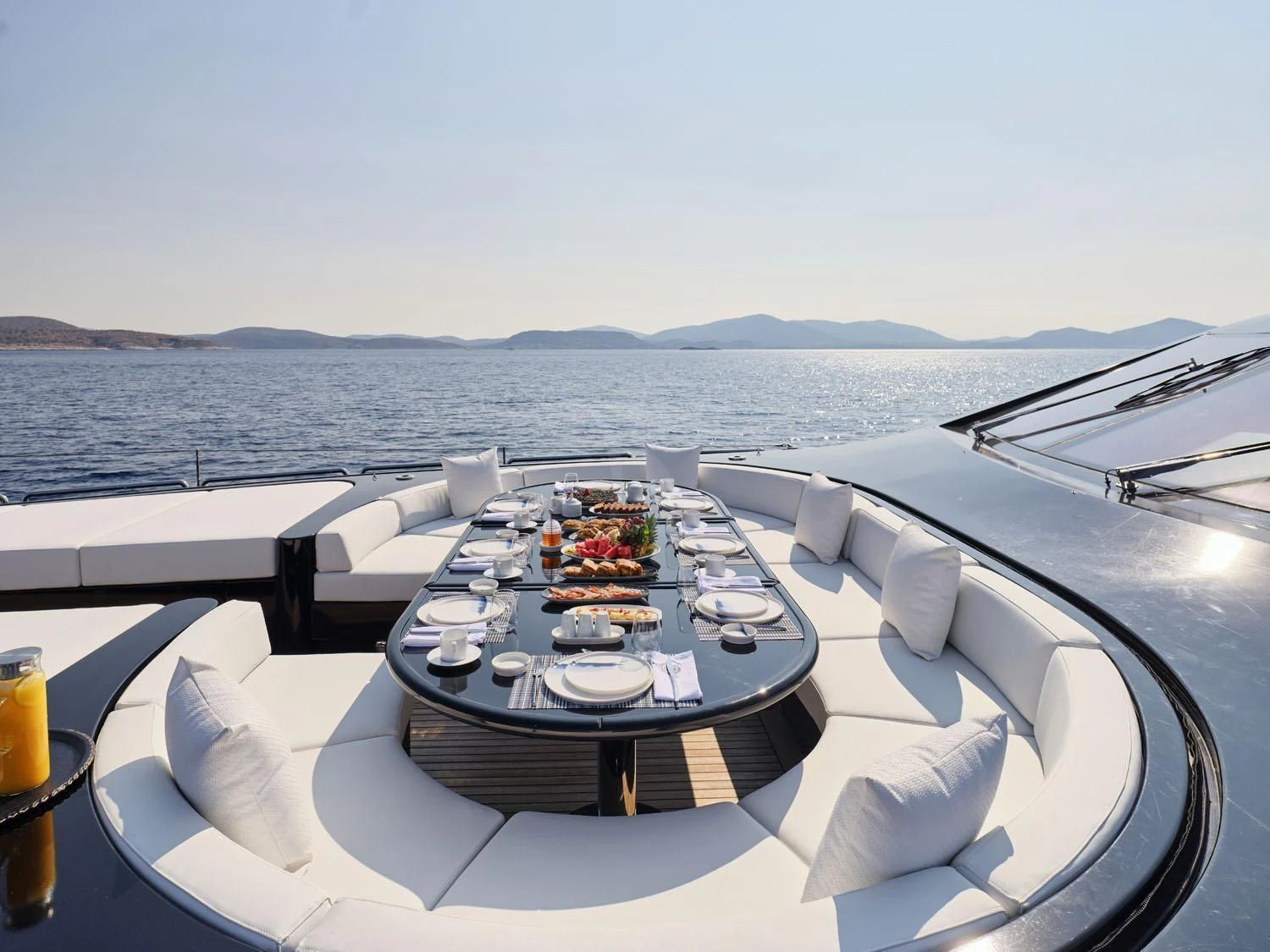 a table with plates and chairs on it aboard ABILITY Yacht for Sale