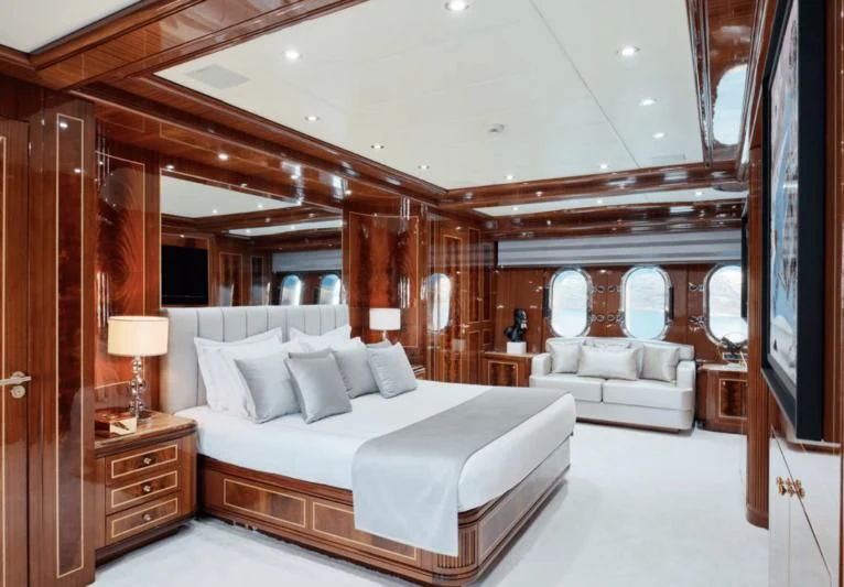 a large bedroom with a large bed aboard ABILITY Yacht for Sale