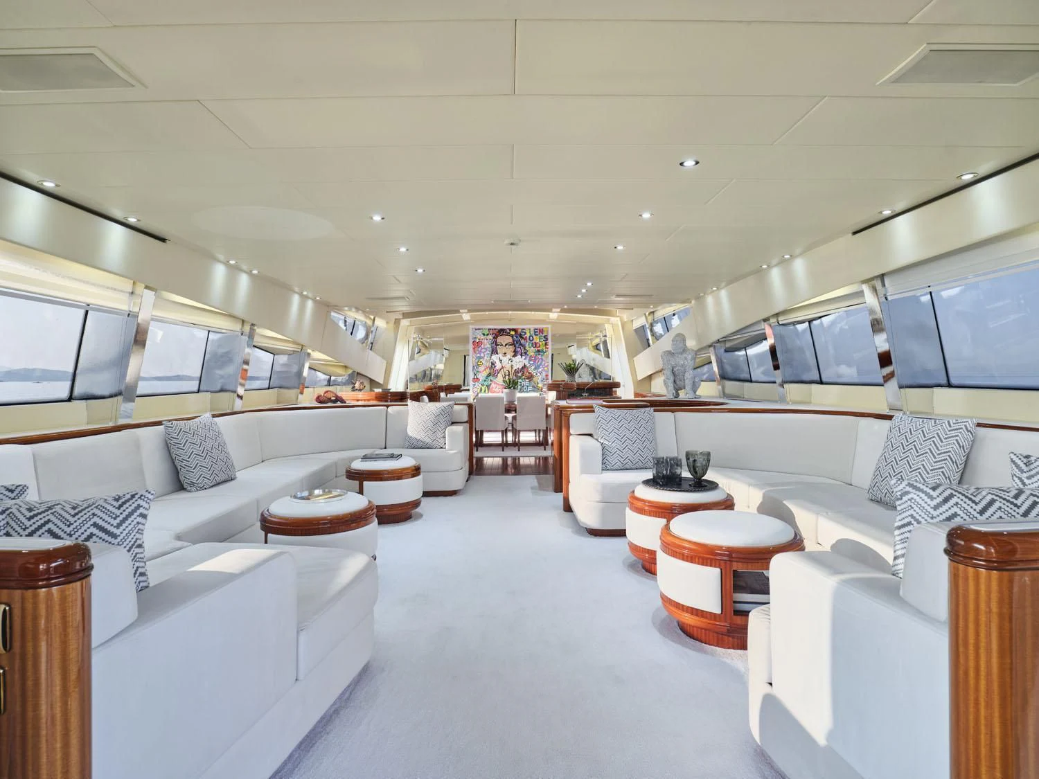a room with white couches and a large window aboard ABILITY Yacht for Sale
