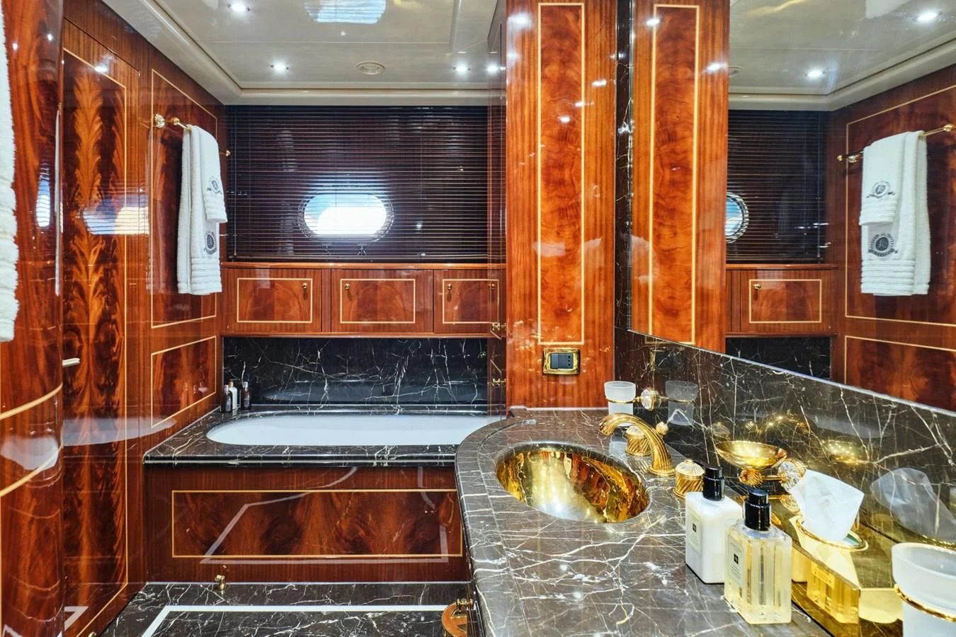 a bathroom with a sink and a large mirror aboard ABILITY Yacht for Sale