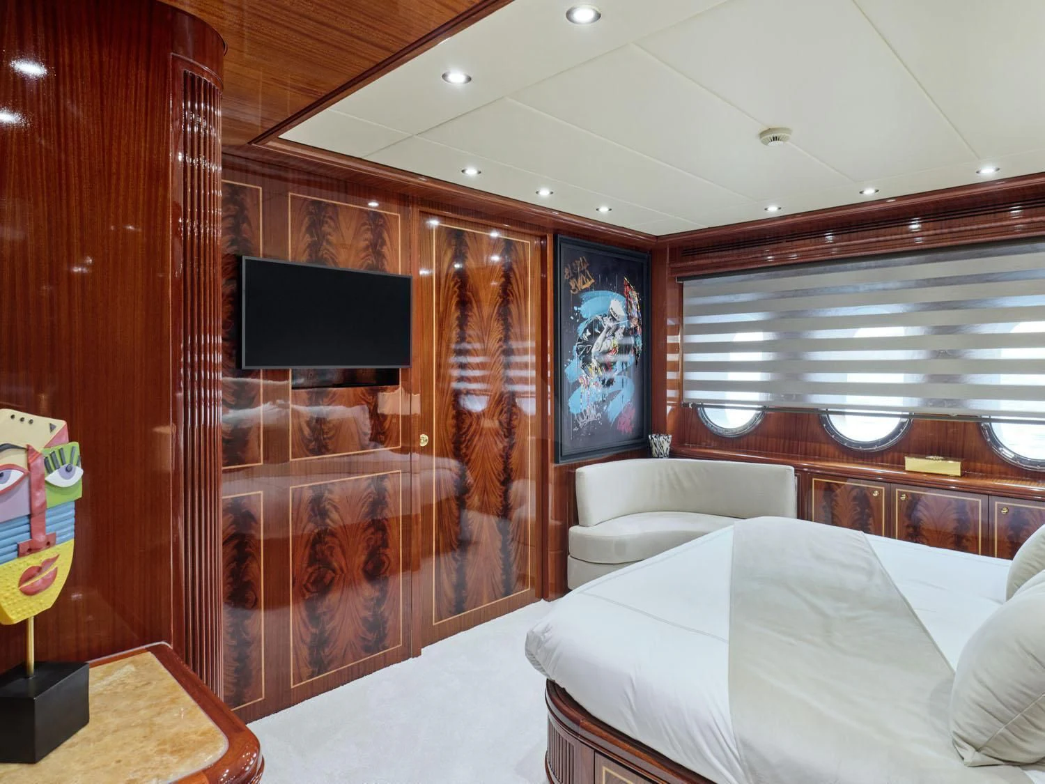 a room with a bed and a television aboard ABILITY Yacht for Sale