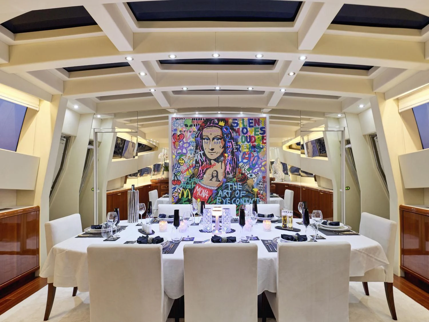 a table with chairs and a painting on it aboard ABILITY Yacht for Sale