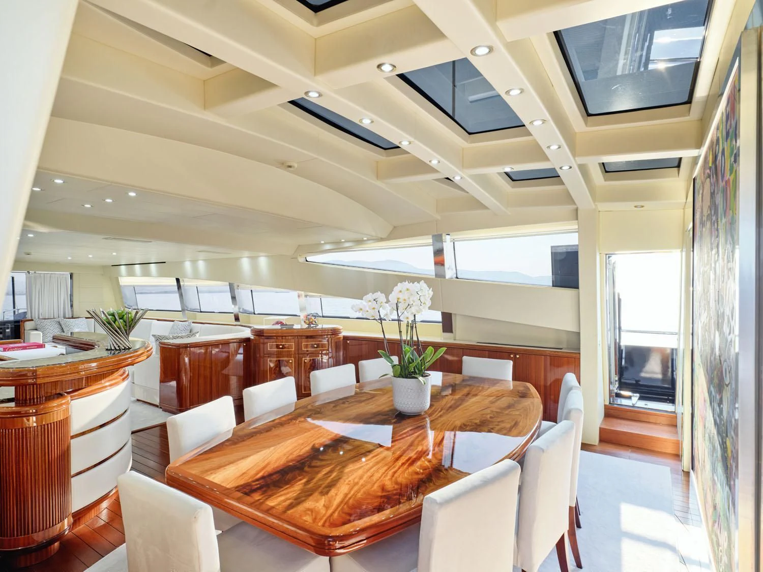 a room with tables and chairs aboard ABILITY Yacht for Sale