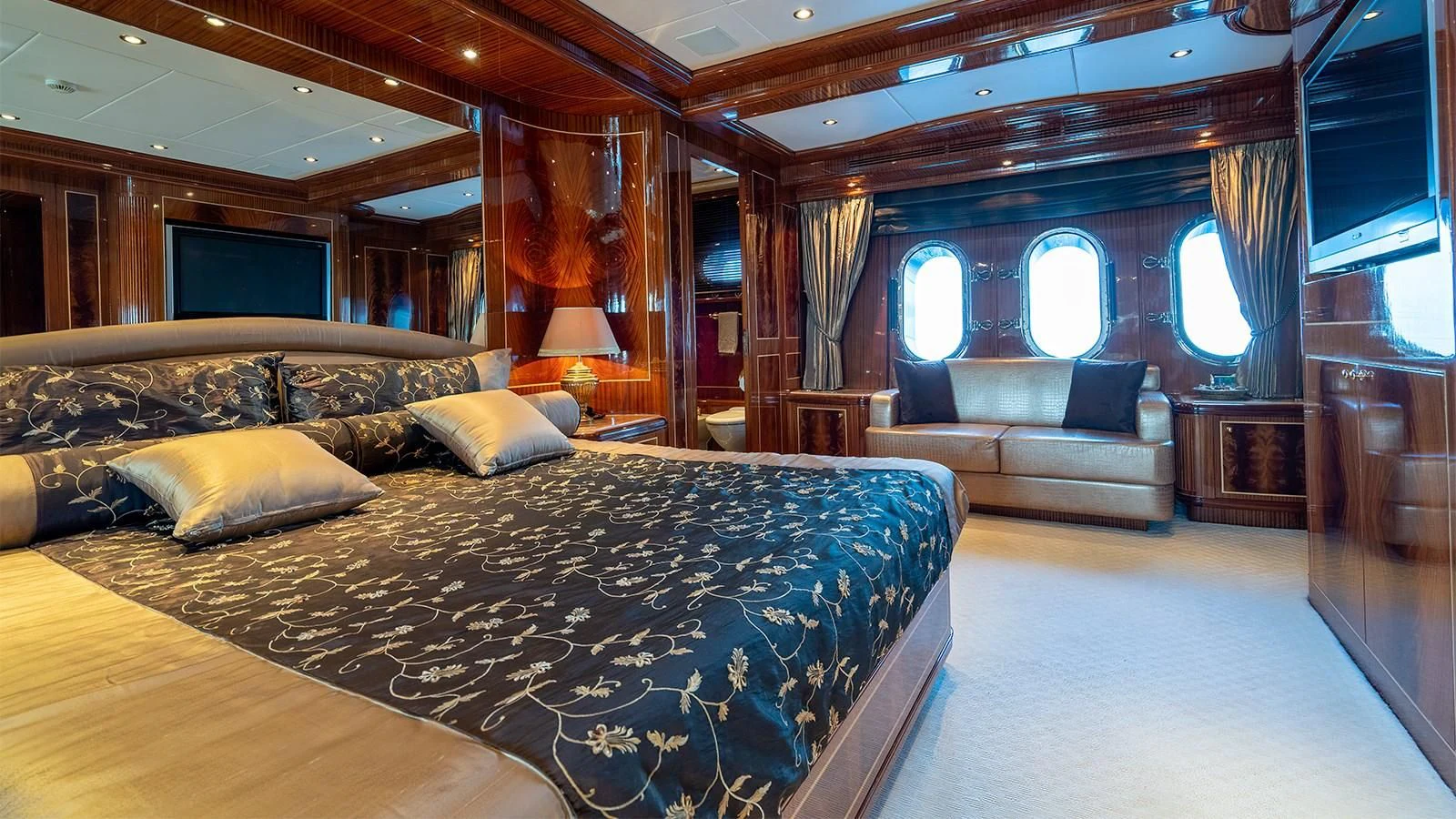 a large bedroom with a large bed aboard ABILITY Yacht for Sale