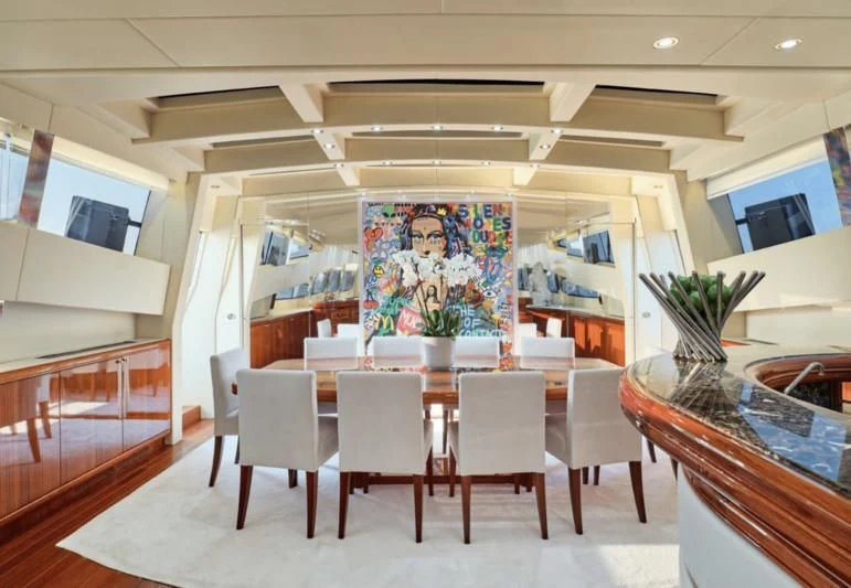 a room with tables and chairs aboard ABILITY Yacht for Sale