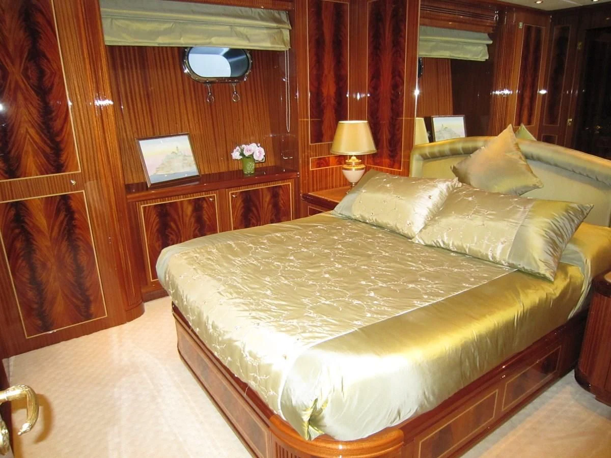 a bed with a white sheet aboard ABILITY Yacht for Sale