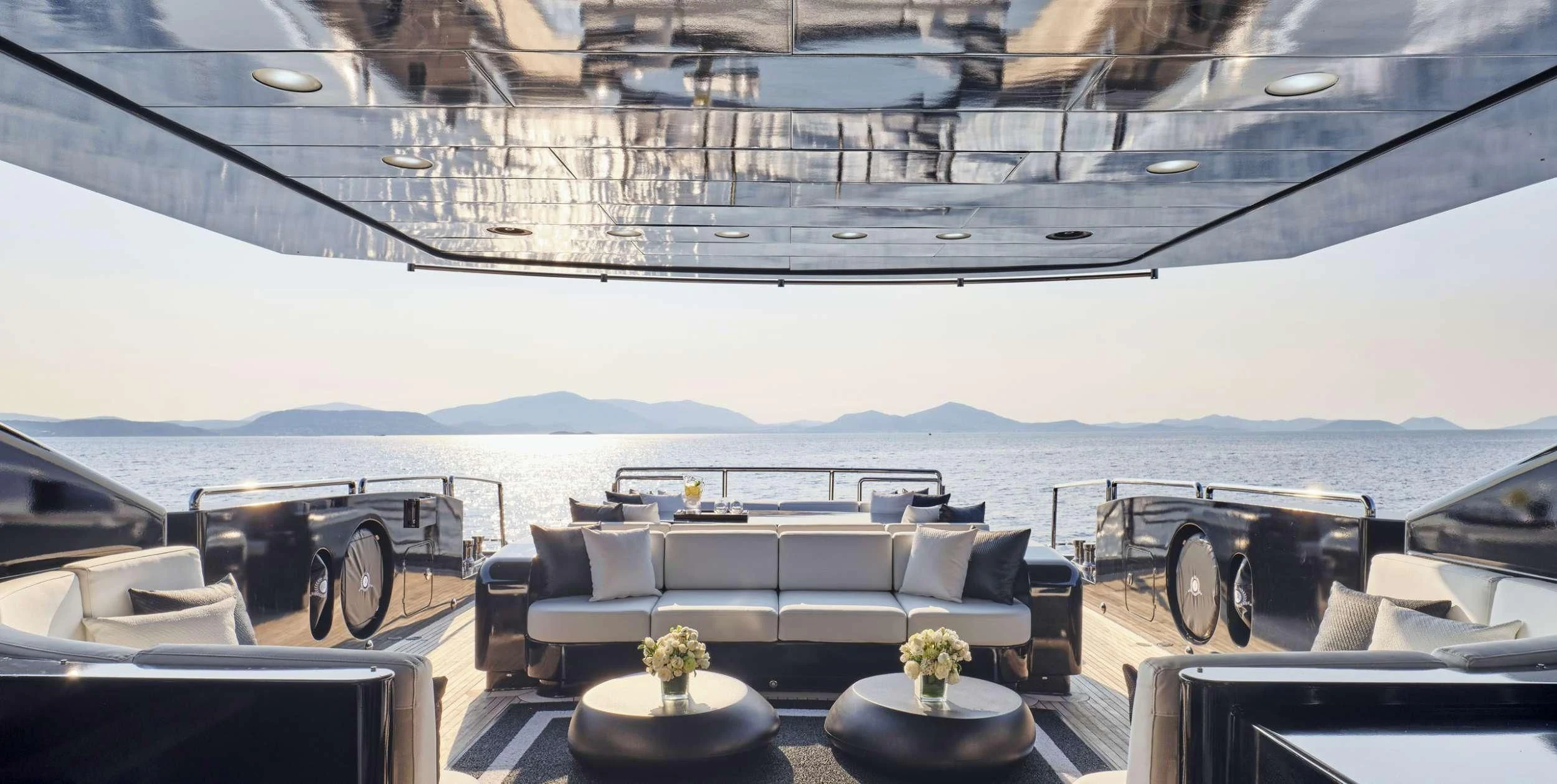 a room with a couch and a table and chairs aboard ABILITY Yacht for Sale