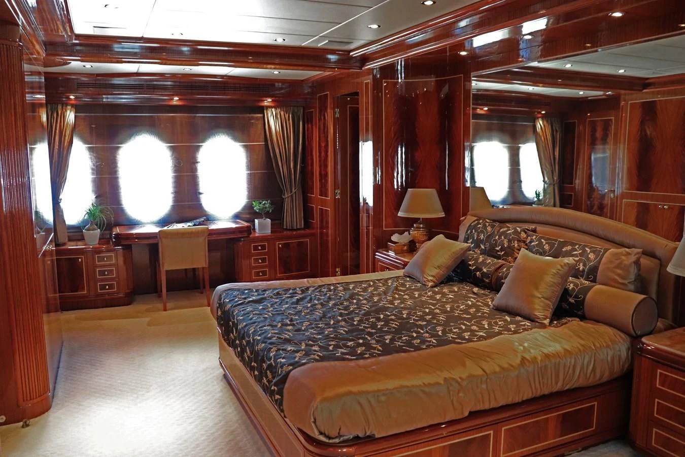 a large bedroom with a large bed aboard ABILITY Yacht for Sale