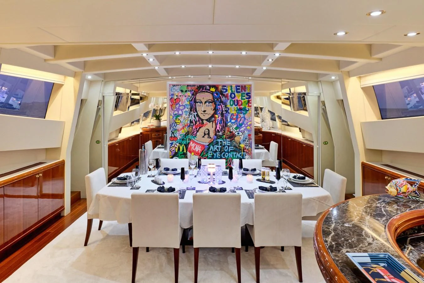 a large room with tables and chairs aboard ABILITY Yacht for Sale