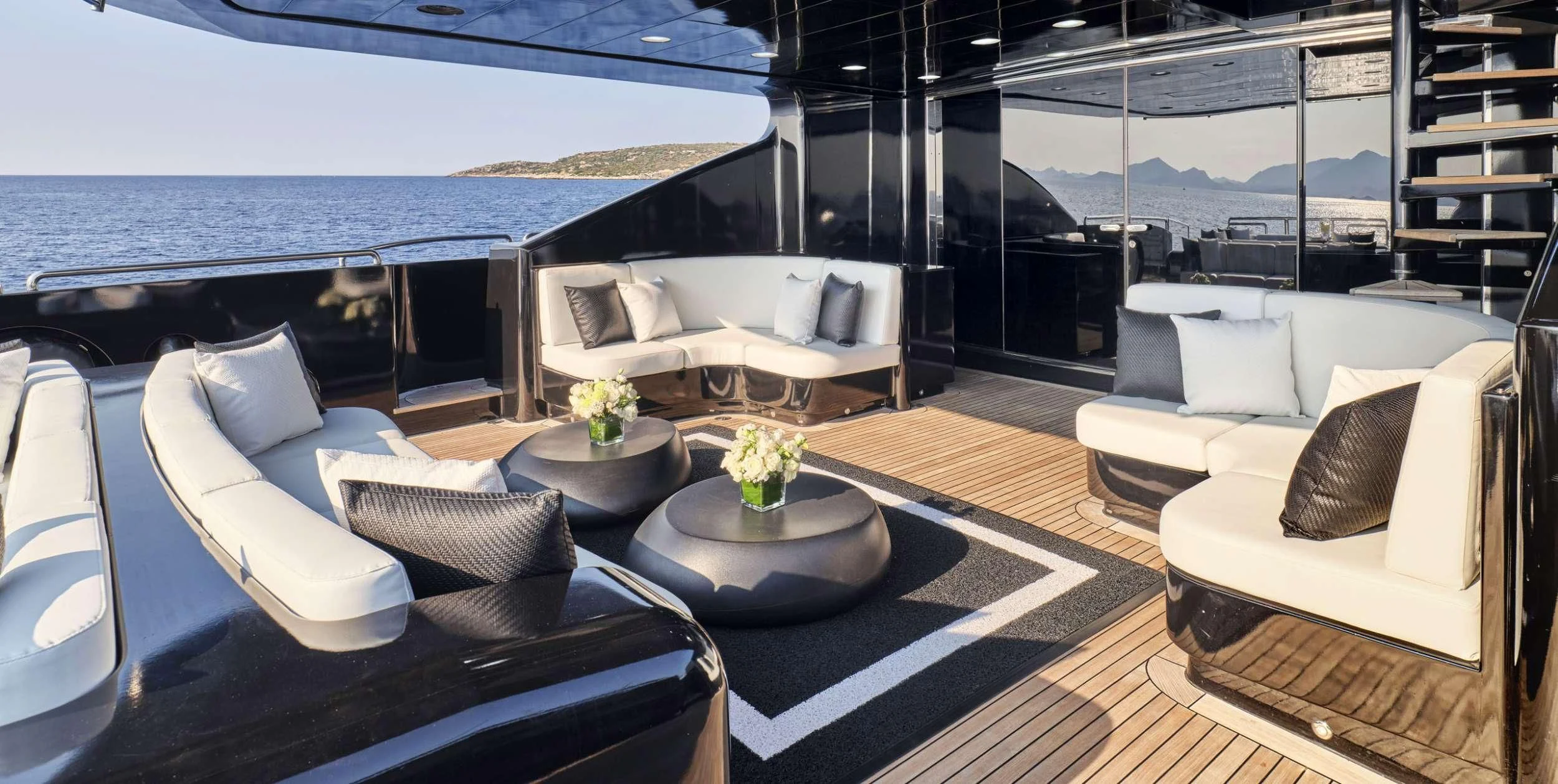 a room with a couch and a table and a large body of water aboard ABILITY Yacht for Sale
