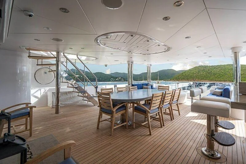 a room with a table chairs and a large glass window aboard SEANASH Yacht for Sale
