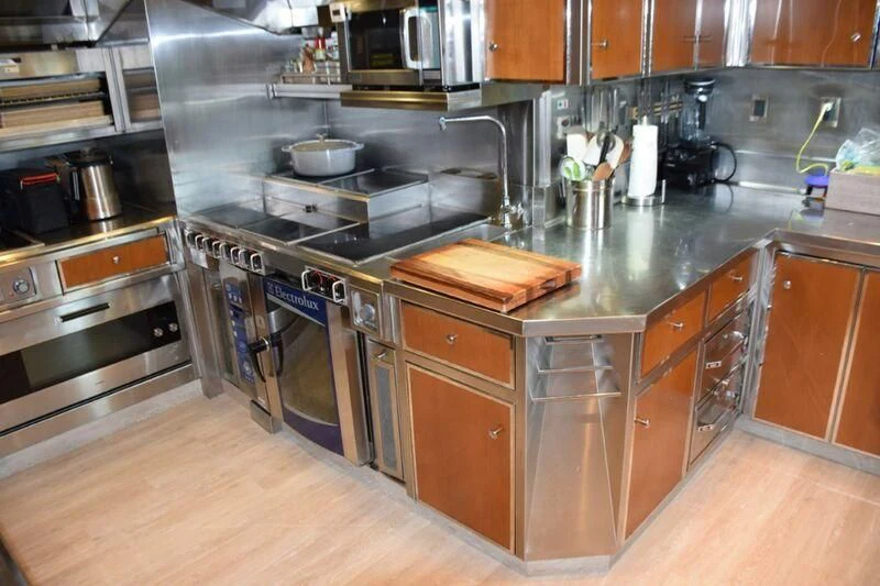 a kitchen with a stove and oven aboard SEANASH Yacht for Sale
