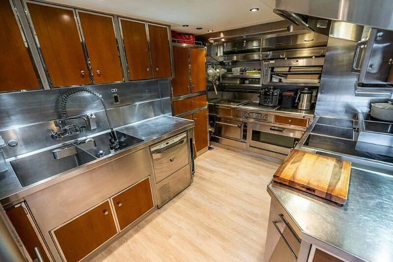 a kitchen with wooden cabinets aboard SEANASH Yacht for Sale