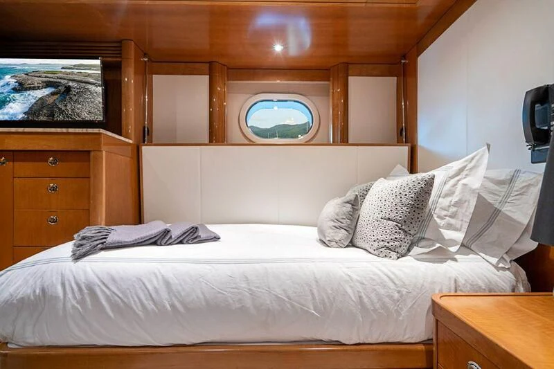 a bed with white sheets and pillows aboard SEANASH Yacht for Sale