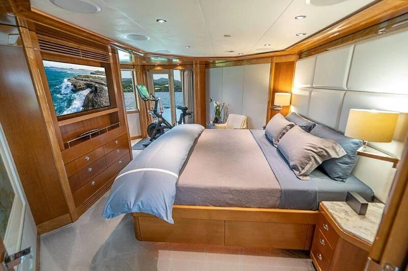 a bedroom with a bed and a bicycle aboard SEANASH Yacht for Sale