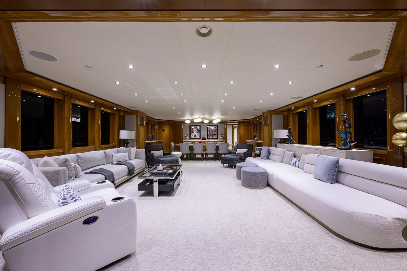 a large room with white couches aboard SEANASH Yacht for Sale