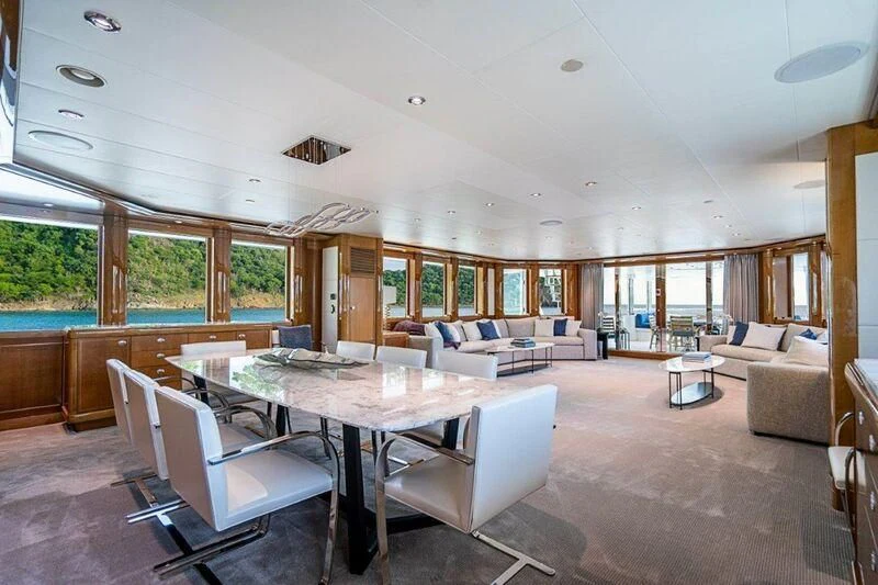 a large living room with a large table and chairs aboard SEANASH Yacht for Sale
