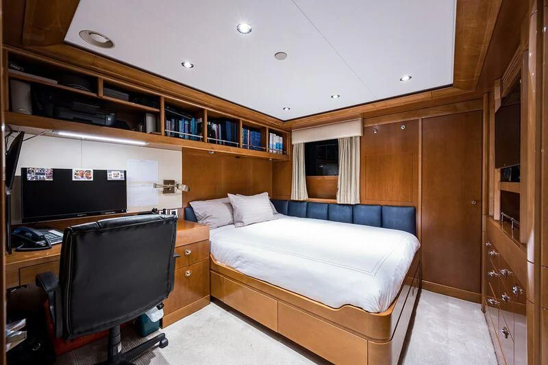 a bedroom with a bed and a tv aboard SEANASH Yacht for Sale