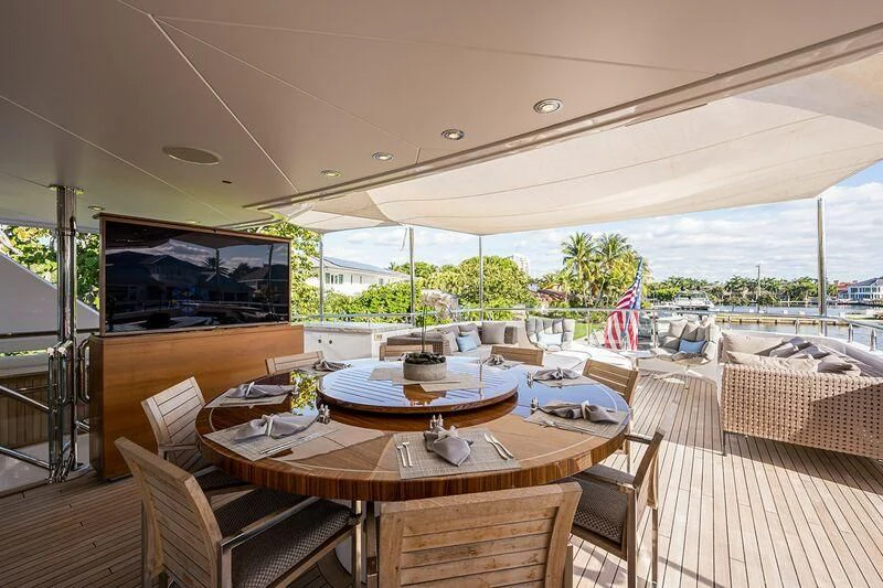 a table and chairs on a deck aboard SEANASH Yacht for Sale