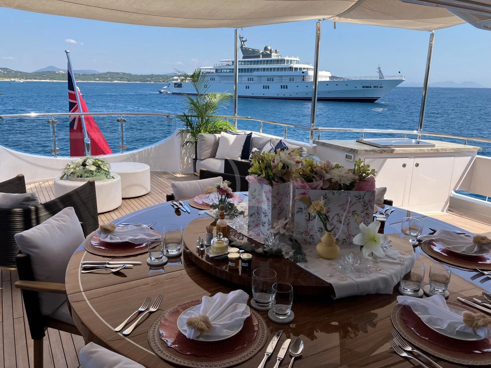 a table set with plates and glasses aboard SEANASH Yacht for Sale