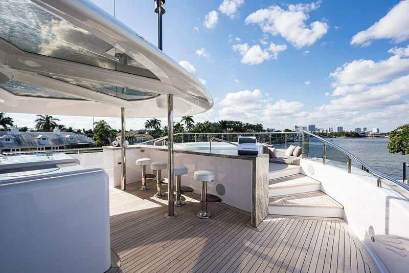 a deck with a pool and a deck with chairs and a deck aboard SEANASH Yacht for Sale
