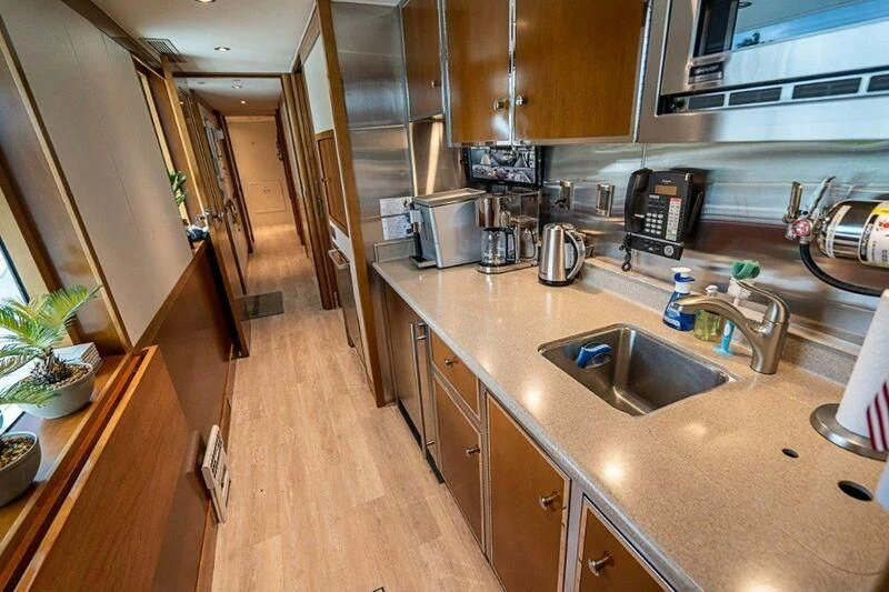 a kitchen with a sink and appliances aboard SEANASH Yacht for Sale