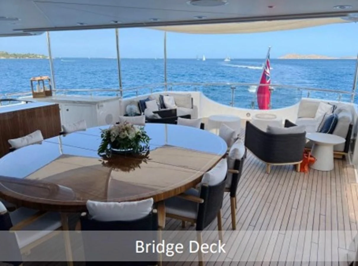 a table and chairs on a deck aboard SEANASH Yacht for Sale