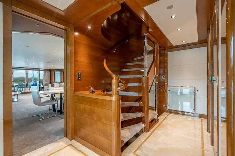 a wood staircase in a room aboard SEANASH Yacht for Sale