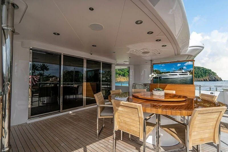 a large room with a table and chairs and a tv on the wall aboard SEANASH Yacht for Sale