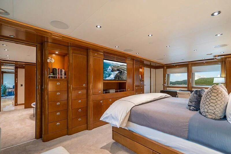 a bedroom with a bed and a dresser aboard SEANASH Yacht for Sale
