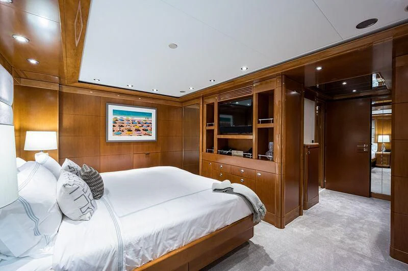 a bedroom with a bed and a closet aboard SEANASH Yacht for Sale
