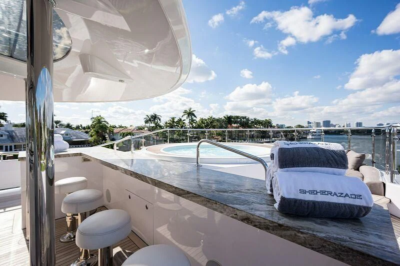 a lounge chair on a deck overlooking a body of water aboard SEANASH Yacht for Sale