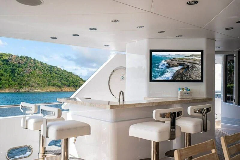 a room with a table and chairs and a tv on the wall aboard SEANASH Yacht for Sale