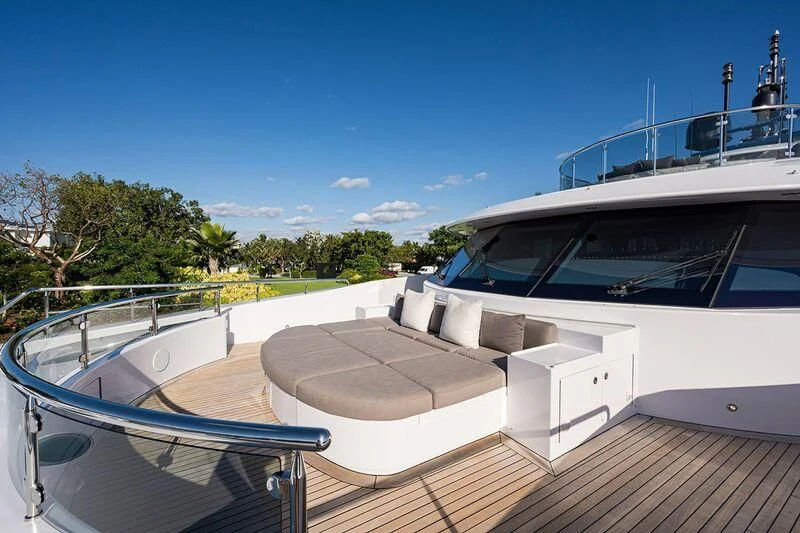 a deck with a boat and a pool aboard SEANASH Yacht for Sale