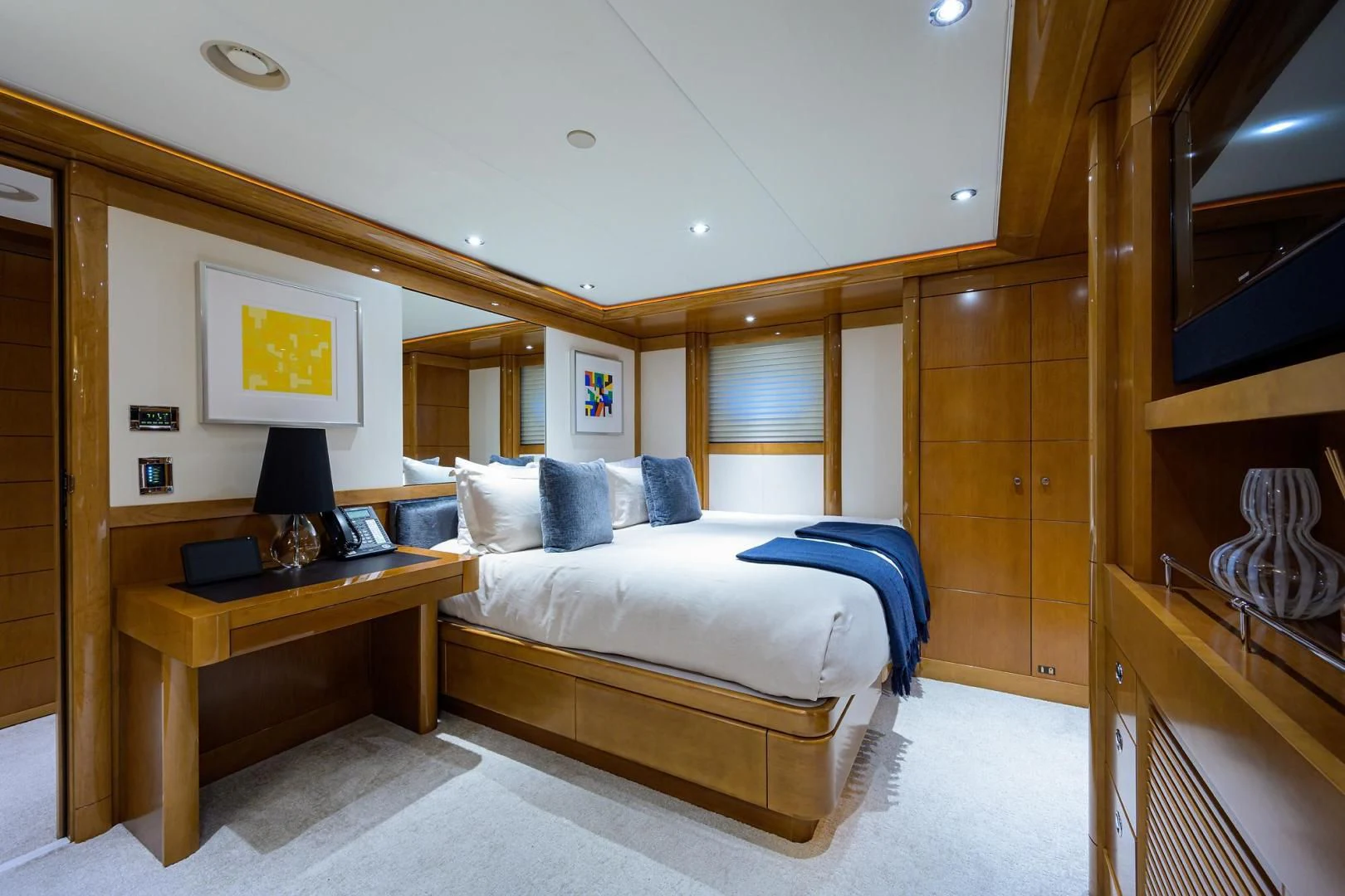 a bedroom with a bed and a desk aboard SEANASH Yacht for Sale