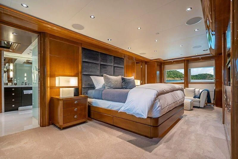 a bedroom with a bed and a mirror aboard SEANASH Yacht for Sale