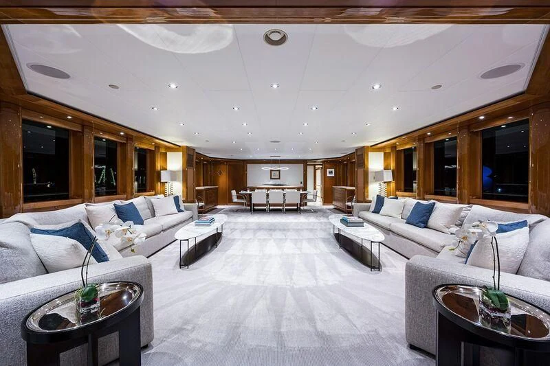 a living room with white couches aboard SEANASH Yacht for Sale