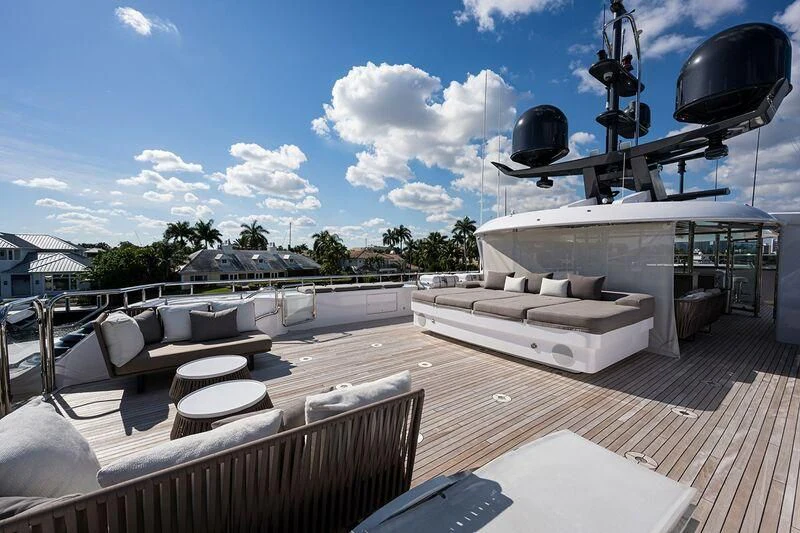 a deck with a large white boat and a large black cannon on it aboard SEANASH Yacht for Sale