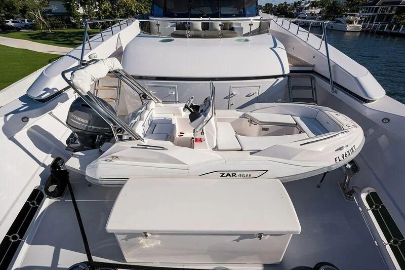 a white boat with a black and white stripe on it aboard SEANASH Yacht for Sale