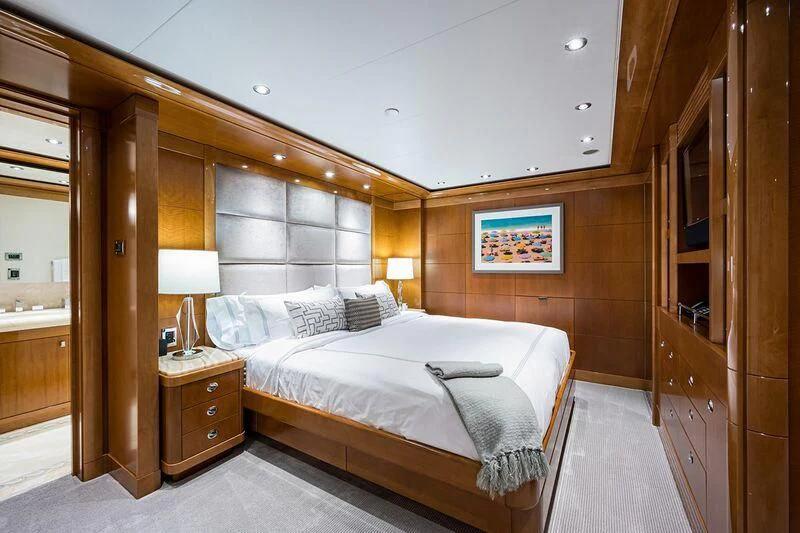 a bedroom with a bed and a wood wall aboard SEANASH Yacht for Sale
